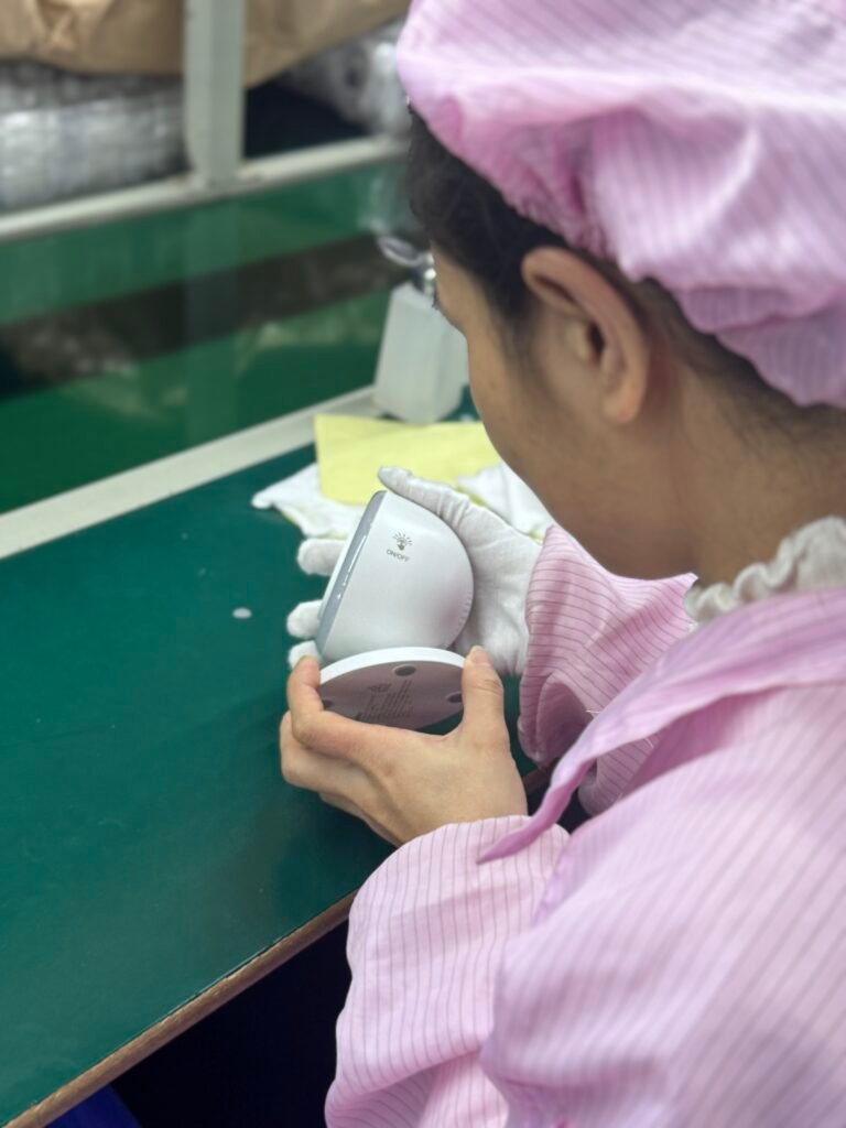 Quality control staff performing a detailed final visual inspection to ensure defect-free wireless charger surfaces.