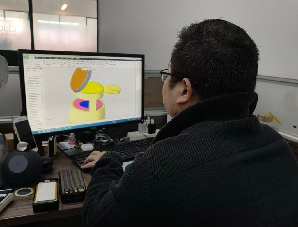 Mechanical engineer conducting structural design and internal component layout for a new wireless charger model using CAD.