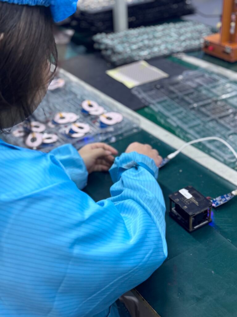 Quality inspection of wireless charging circuit boards to ensure voltage stability and connection quality.
