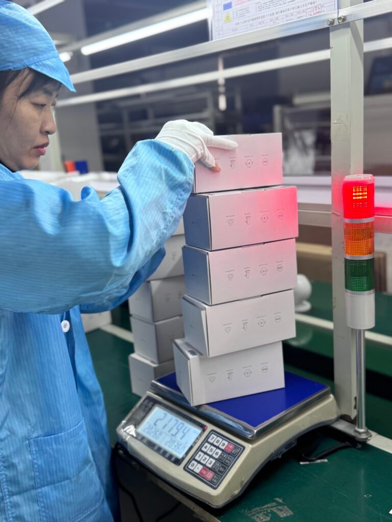 Final quality check: Weighing wireless charger packages to detect missing parts and ensure shipment completeness.