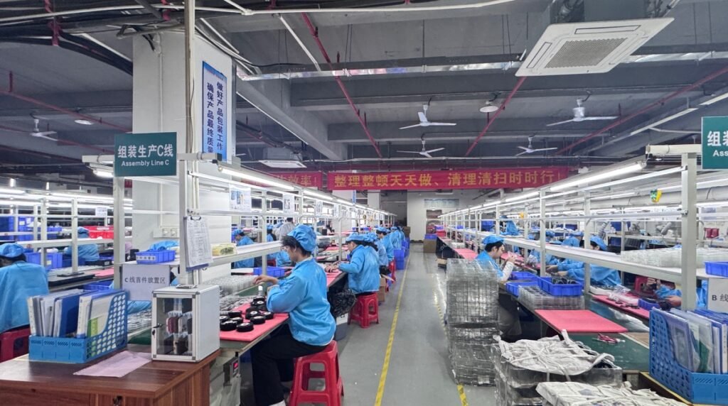 Busy wireless charger assembly line with skilled operators and automated conveyors ensuring efficient mass production and timely delivery.