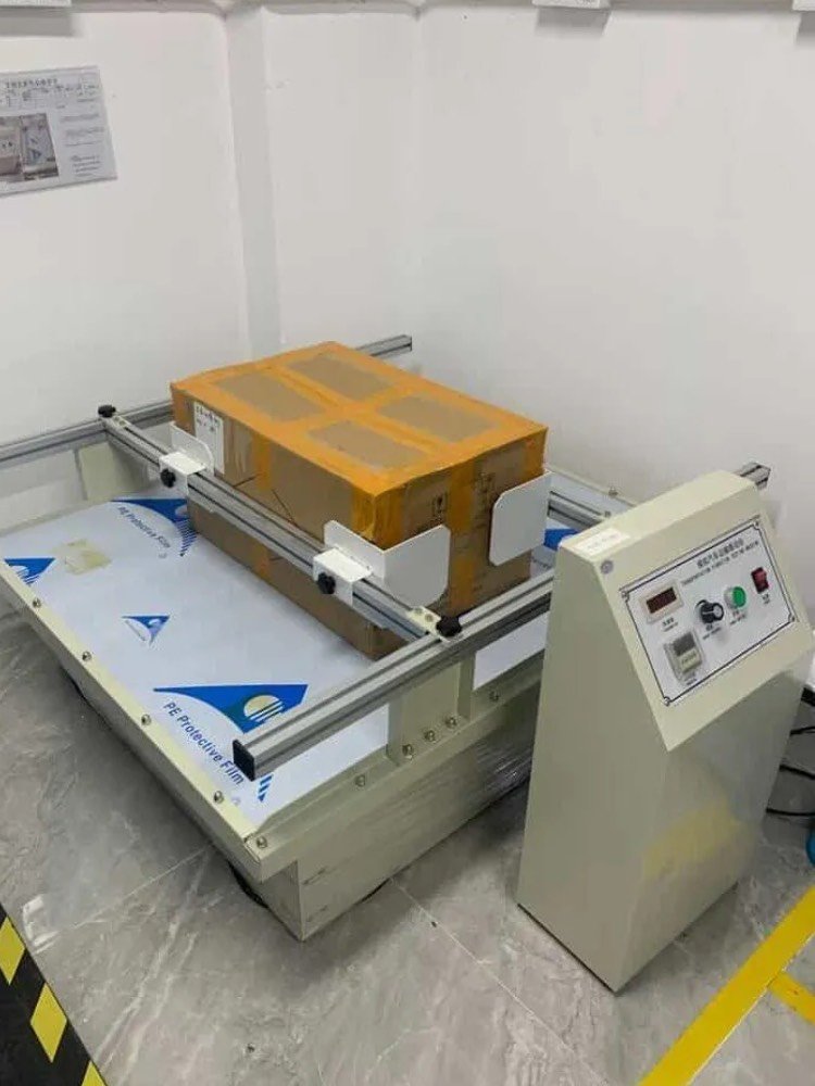 Simulated vehicle transportation vibration tester shaking packaged wireless chargers on testing platform